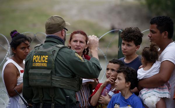 Immigrants who crossed the Rio Grande are stopped by Border Patrol, May 22, 2022.