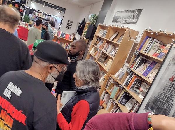 People mingle at New York City Revolution Books Open House, December 11, 2022.
