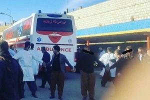 People making a human chain, surrounding an ambulance to prevent Iran’s security forces from using it to kidnap the wounded.