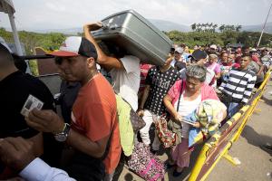 Venezuelan refugees wait to cross the border into Colombia.