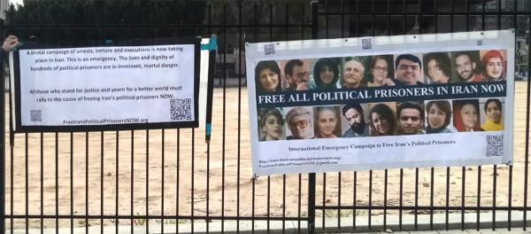 IEC banners hang on fence in Los Angeles calling for support for Iran political prisoners, February 2023.
