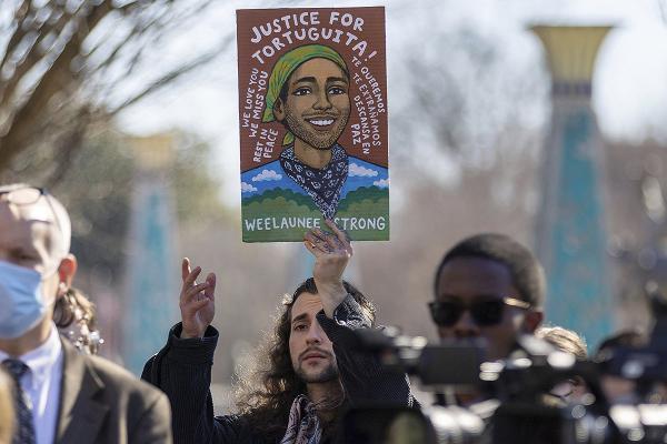 Protester holds sign honoring Tortuguita, murdered while defending the forest site of Atlanta's Cop City, February 2023.