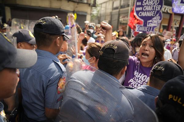 Philippines, IWD 2023, protester shouts at police temporarily blocking march.