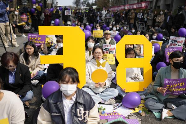 South Korea, IWD 2023, activists with placards on discrimination against women .