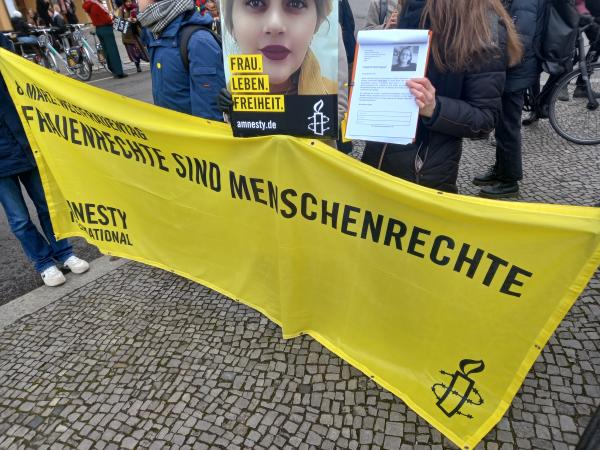 Berlin, Germany, part of International Women's Day march, holding pictures of Iranian women