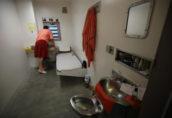 Inmate looks out window in a solitary confinement cell in the main jail in San Jose.