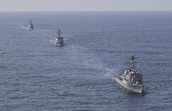 U.S. Navy's the guided missile destroyer USS Benfold, right bottom, South Korean Navy's destroyer Yulgok Yi I and Japan Maritime Self-Defense Force's destroyer Atago, left top, sail during a joint missile defense drill in South China Sea, April 17, 2023.