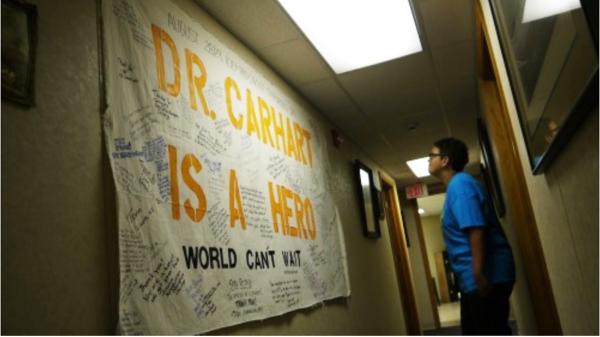Banner that says "Dr. Carhart Is A Hero" was signed by many people.