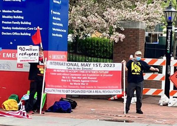 Boston, May First, revcoms with banner at Boston Medical Center