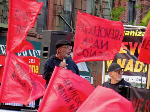 New York City, May First, Carl Dix and Larry Everest speak from truck in midst of red flags