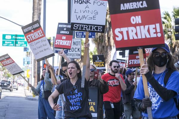 Members of the The Writers Guild of America (WGA) picket outside the Netflix, Inc., building on Sunset Blvd, on Friday, May 5, 2023, in Los Angeles.