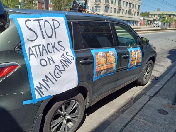 Car decorated for Chicago RevClub outing with the proclamation WE ARE THE REVCOMS and "Stop Attacks on Immigrants."