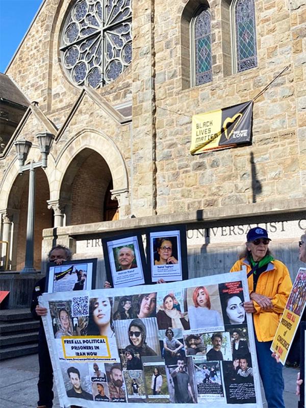 San Francisco, June 21, 2023: An activist with the UUSF and supporter of the IEC with poster of Iran political prisoners.