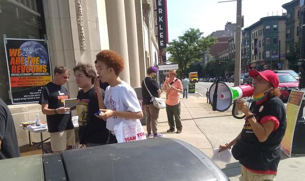 outside the Berklee School of Music at a busy student intersection.
