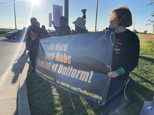 Chicago Rev Coms unfurl banner to protest Aldean's "small town."