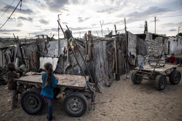 Palestinian woman stands near her house on the outskirts of Khan Younis Refugee Camp in the southern Gaza Strip, November 2020.