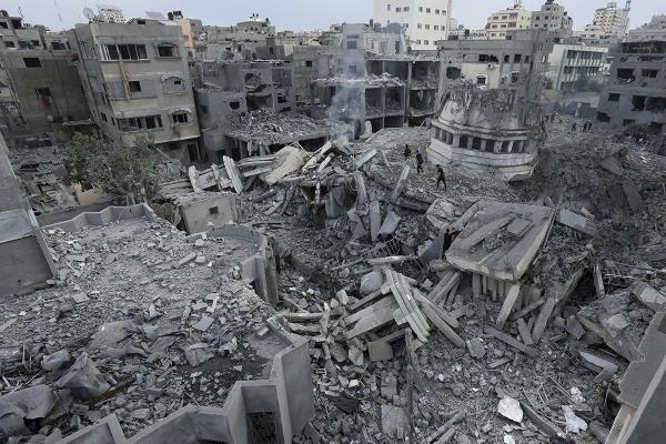 Palestinians inspect the rubble of the Yassin Mosque, destroyed after it was hit by an Israeli airstrike at Shati refugee camp in Gaza City, October 9, 2023.