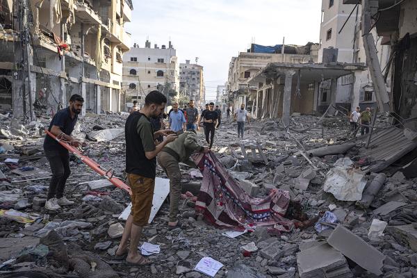 Palestinians collect dead from the rubble after the Israeli bombing in Gaza City, October 11, 2023.