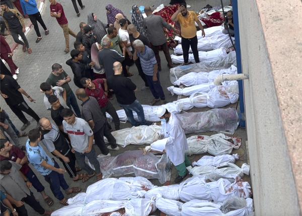 Shrouded bodies lie outside Indonesia Hospital following Israeli airstrikes at the Jabaliya refugee camp, October 31, 2023.