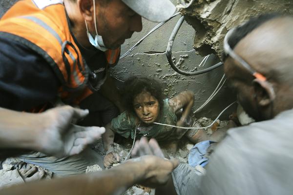 Palestinians pull girl from rubble after Israeli airstrike on Jabaliya refugee camp, November 1, 2023.