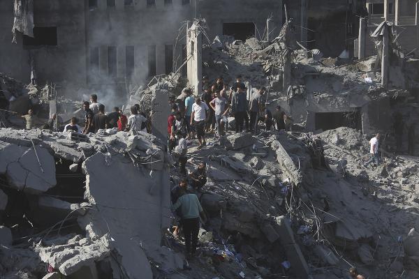 Palestinians look for survivors following an Israeli airstrike in Bureij refugee camp, Gaza Strip, November 2, 2023.