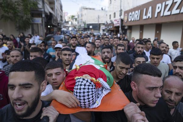 Mourners carry the body of Ayham Shafe'e, 14, killed during Israel army raid, November 2, 2023.