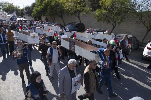  Palestinian journalists carry mock coffins of Palestinian journalists who were killed during the current war in Gaza.