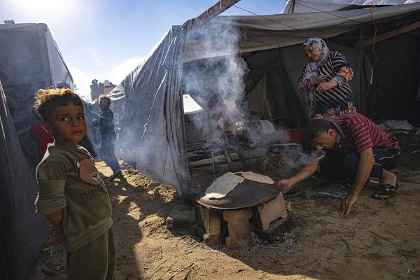 People in tents cooking at a Gaza Strip refugee camp, November 15, 2023.