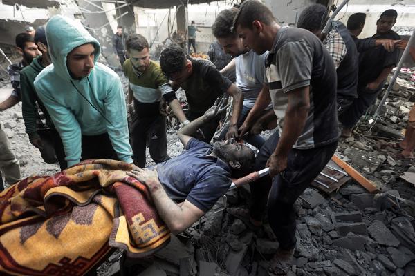 Injured man in Khan Younis refugee camp pulled from rubble, November 18, 2023.