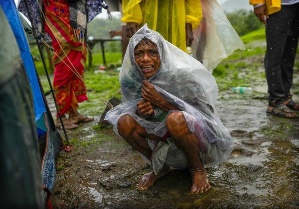 A woman whose family members are trapped under rubble after extreme weather caused a landslide that buried people in western India, July 2023. 