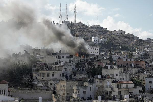 Fire and smoke arise from Israeli occupation of Jenin, West Bank, December 13, 2023