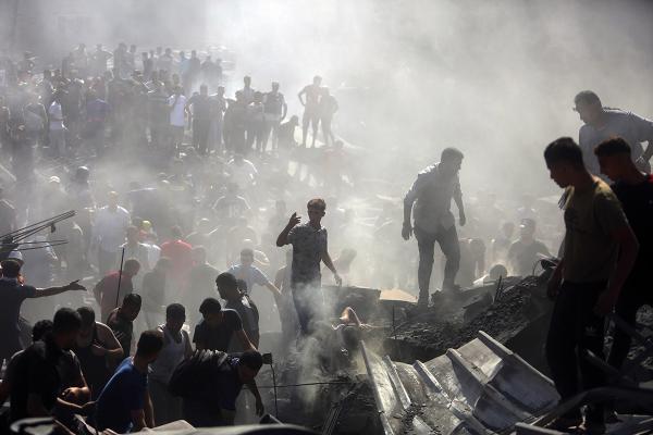 Palestinians search through rubble in Khan Younis after Israeli airstrikes, October 26, 2023.