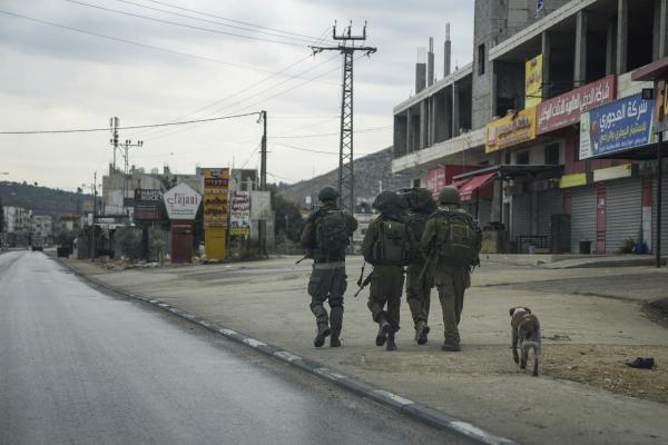 Israeli troops patrol a town where Palestinians were driven out in November, 2023