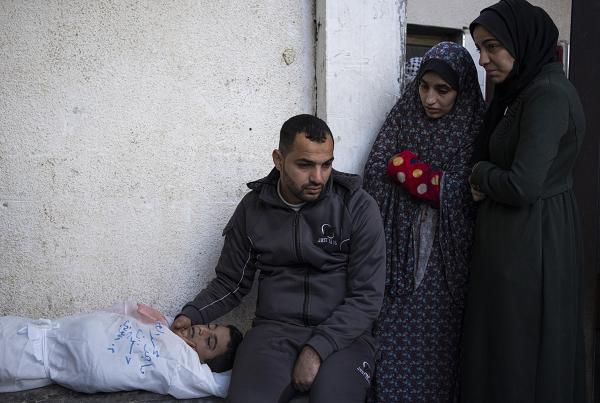 Family mourns child's death, one of dozens killed in Israeli bombardments of Rafah.