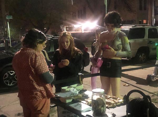 The revcoms chat with students outside a University of Texas residential co-op during an unofficial SXSW event.