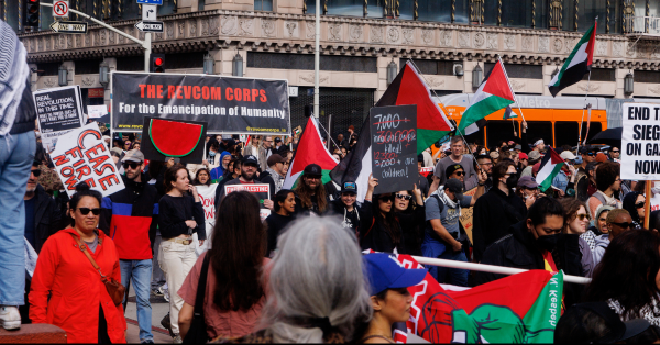 The Revcom Corps banner in the midst of thousands in Los Angeles who came into the streets on a rainy day to protest genocide in Palestine, March 2, 2024.