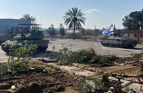 A tank with an Israel flag on it enters the Gazan side of the Rafah border crossing, May 7, 2024.