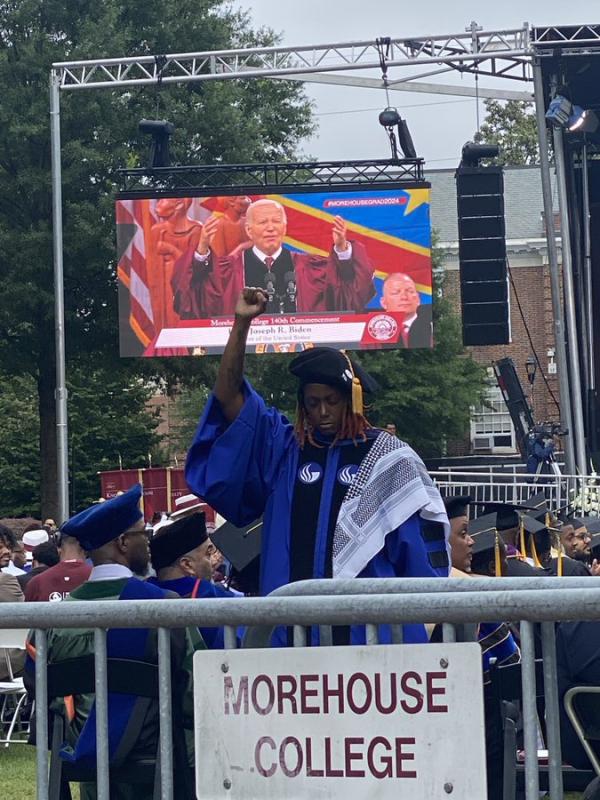 At Morehouse College commencement, faculty member turns her back and raises her fist in protest during Biden's speech