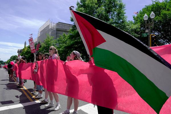 Pro-Palestinian protesters carry a red banner representing a "red line" in front of the White House in Washington, June 8, 2024.