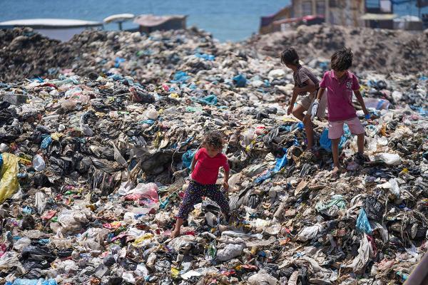 Children search landfill near refugee camp at Nuseirat, June 20, 2024.