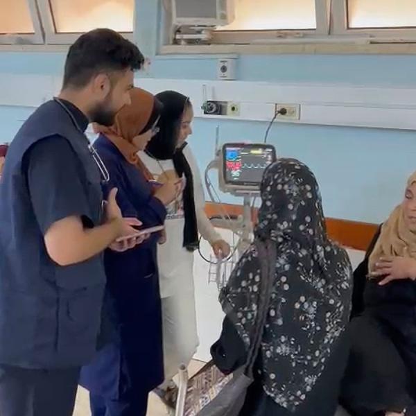 Dr. Majed Jaber (in blue vest) treating patients at European Gaza Hospital, June, 2024.