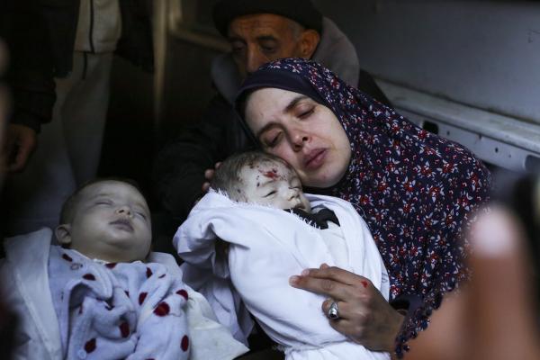 Mother cradles her dead twins, killed in Israeli strike in Rafah, March 2024. 