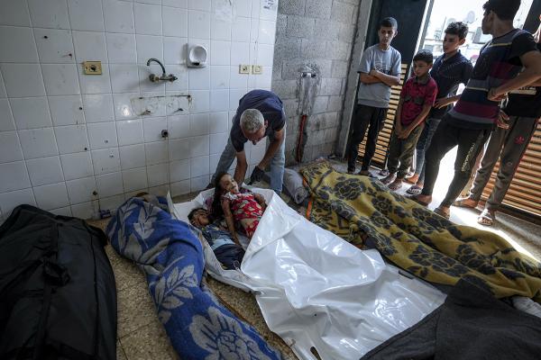 Checking bodies from Israeli bombardment of Gaza Strip at a hospital morgue in Deir al-Balah, July 13, 2024