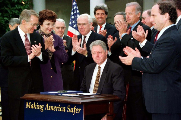 Signing The Biden Crime Bill of 1994. Feinstein, Kerry, and Biden are clearly visible with President Clinton. 