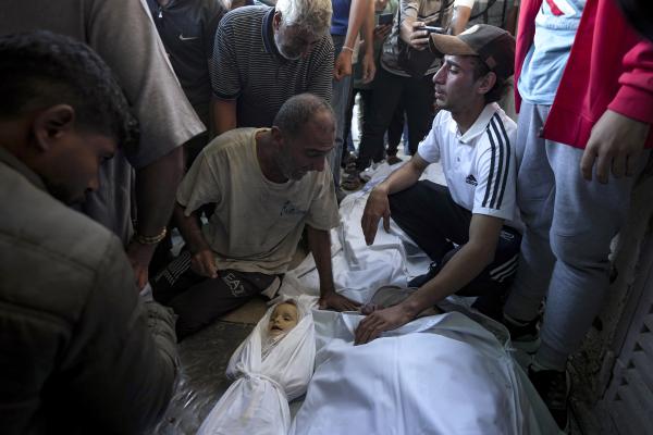 A child among the bodies at hospital morgue in Deir al-Balah, Gaza Strip, October 2, 2024. 