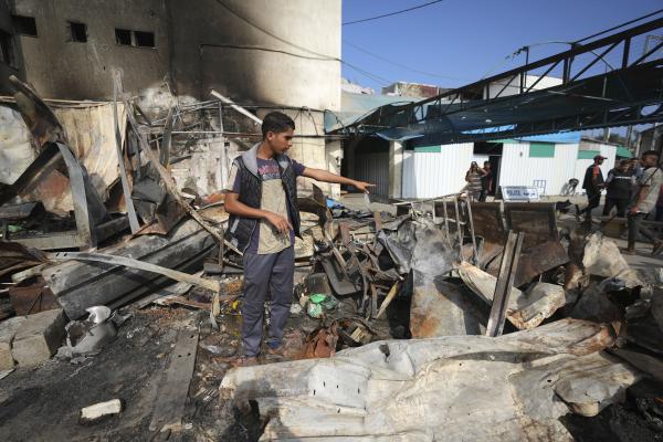 Mohamed al-Dalou points to where his brother, Shaban, burned to death when an Israeli airstrike ignited refugee tents at Al Aqsa Martyrs hospital in the Gaza Strip, October 16, 2024.