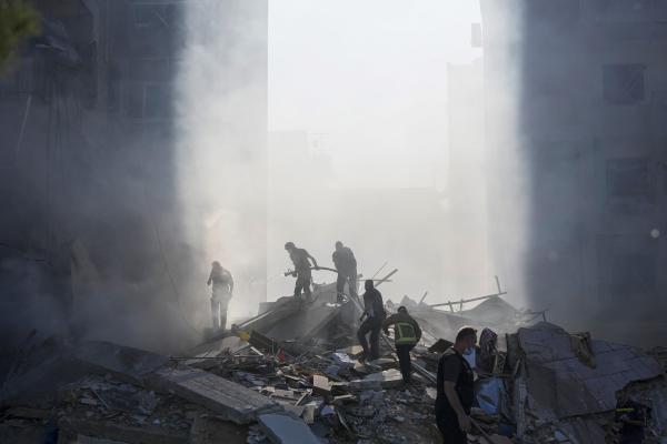 Lebanon civil defense workers search smoking rubble from an Israeli airstrike in Tayouneh, Beirut, November 15, 2024.