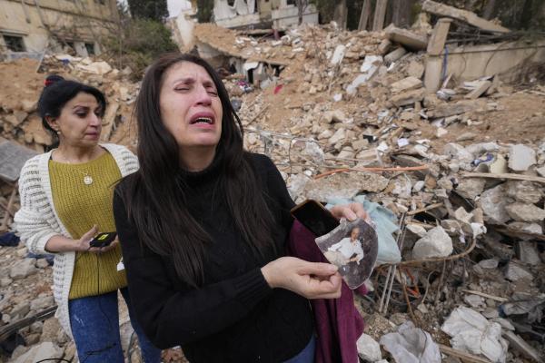 Lebanese woman with photo of her father from the rubble of her destroyed house in Baalbek, eastern Lebanon, November 28, 2024.