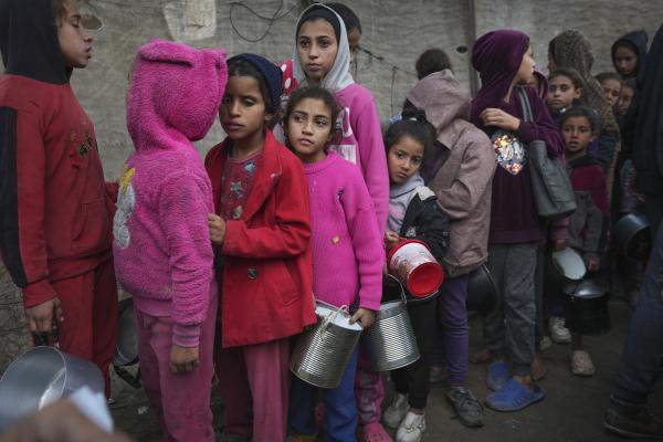 Palestinian children queue for food at a center in Deir al-Balah, Gaza Strip, November 28, 2024.