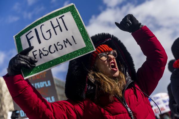 Woman with sign Stop Fascism, Ypsilanti, Michigan, February 17, 2025.
